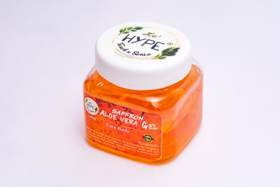Close-up of a saffron aloe vera gel in a clear plastic container, ideal for skin care use.